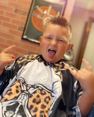 Young client enjoying his fresh haircut