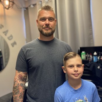 Barber with a young client after his haircut